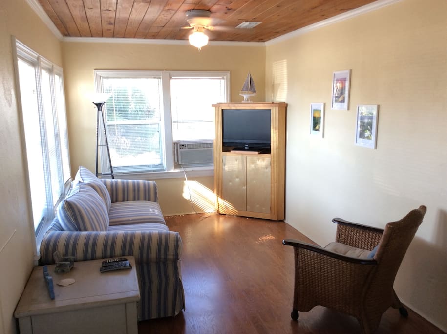 Living Room with 32" flat screen TV and sleeper sofa with queen sized memory foam mattress.