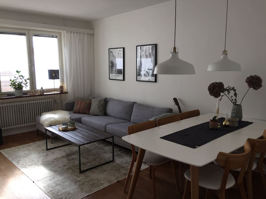 Living room large sofa and entrance to a spacious and sunny balcony located towards the green and calm cortyard.