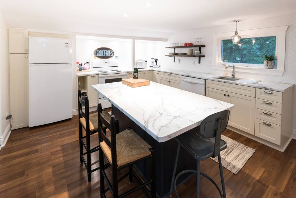 Large, newly renovated kitchen with full sized fridge, dishwasher, stove.