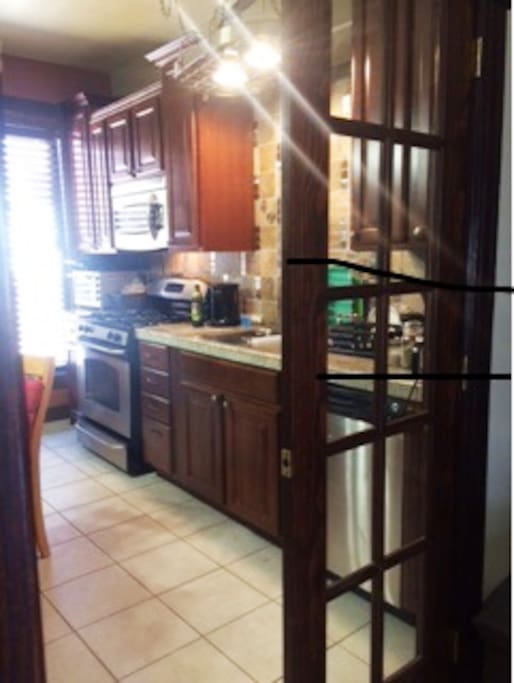kitchen with all stain steel appliance including microwave, dishwasher, and full size washer and dryer.