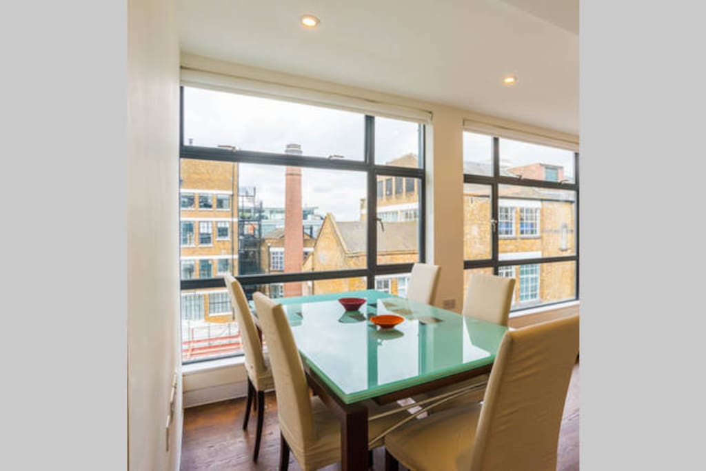 Entertain in style. Ligne Roset table and chairs with seating for 8 and a cool urban view