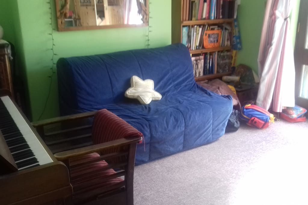 Playroom with piano,guitars toys and books.