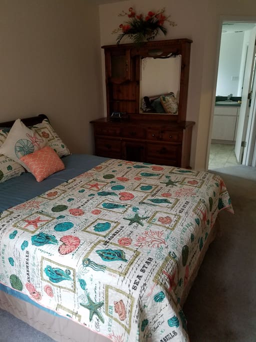 Master bedroom/bath queen size bed and dresser with mirror.