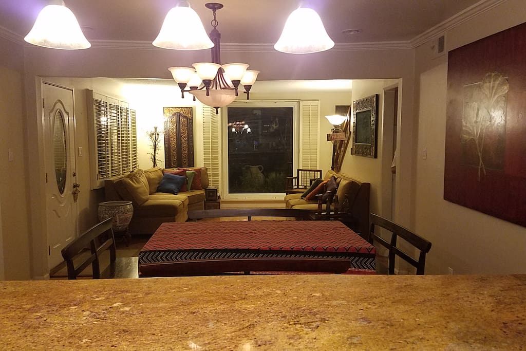 Living and dining area shown from kitchen angle.