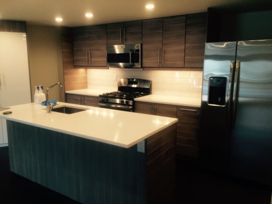 Kitchen - gas range/oven, sink and dishwasher in island.