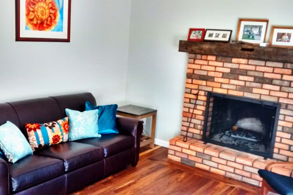 Living room with wood burning fireplace.