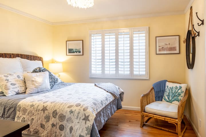 Bedroom #4 with a queen size bed located on the main level of home.