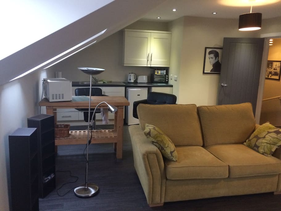 Open plan kitchen and lounge with sofa bed