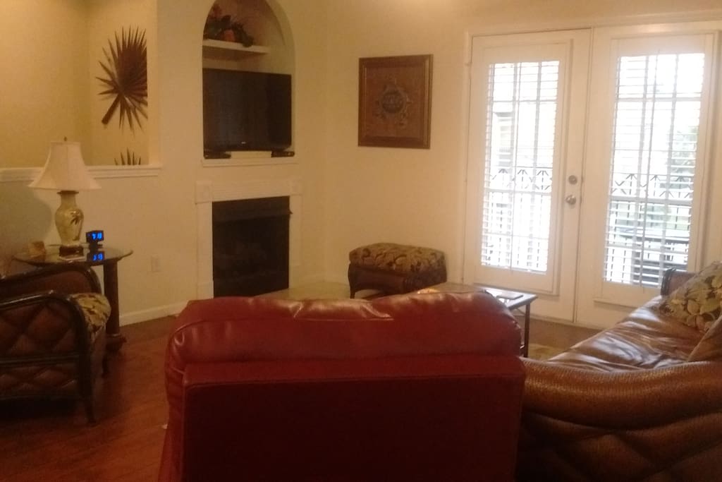 As you walk up the stairs you are welcomed by the openness and warmth of the living room.