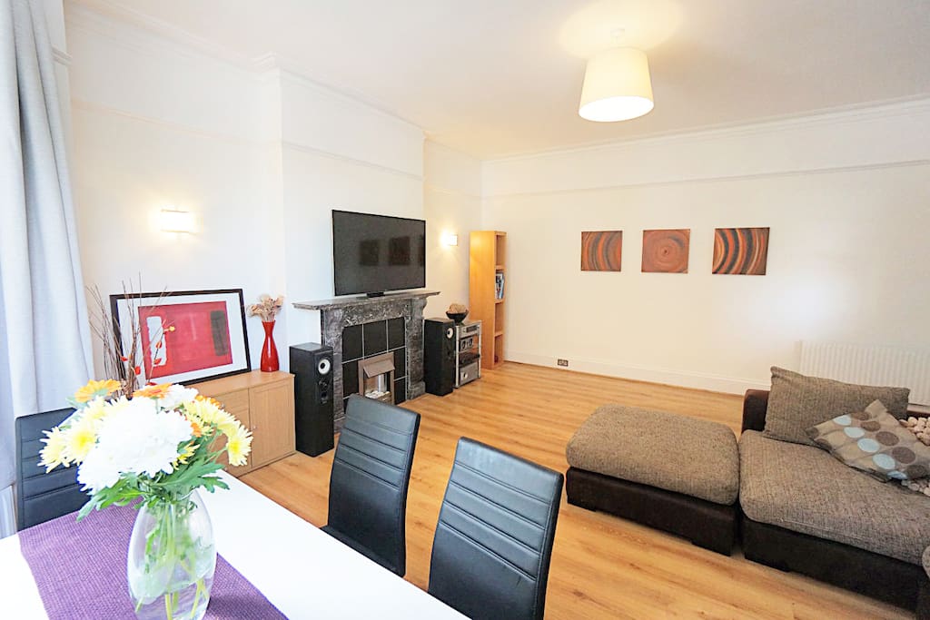 lounge with corner sofa, dining table, flat screen TV, DVD player