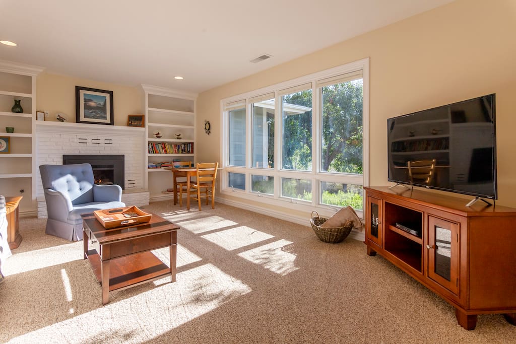 Living room includes a gas fireplace, game table, and LCD television for watching your favorite shows.