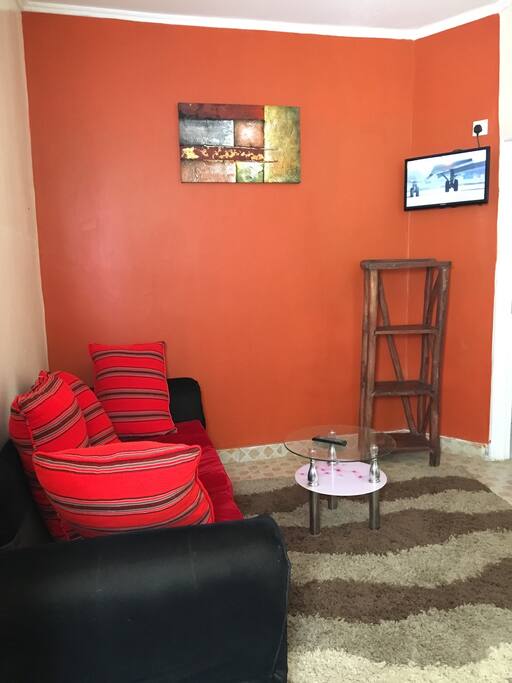Sitting room with TV and mini fridge. Utensils provided per need