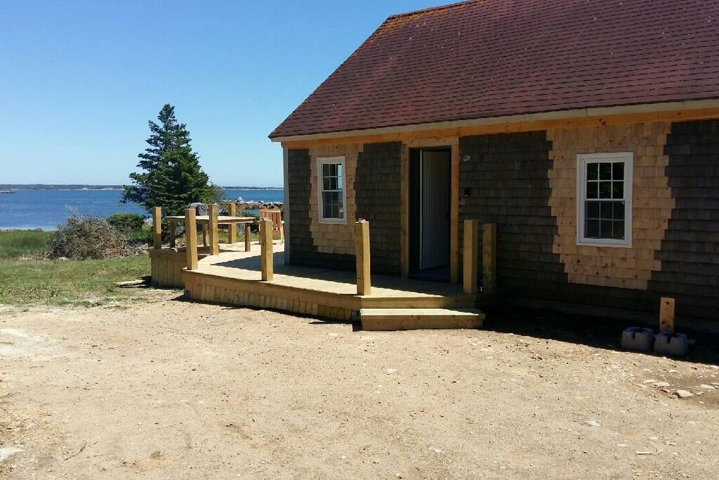 Front door with porch flowing into new 16'x22' ocean side deck