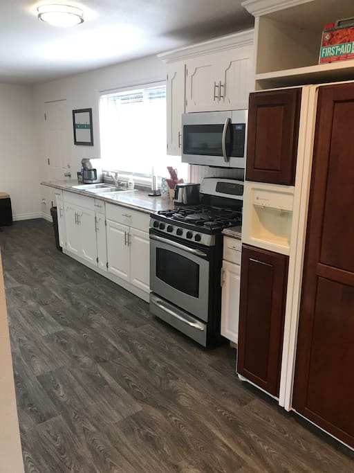 Gas range, microwave, and full size refrigerator.