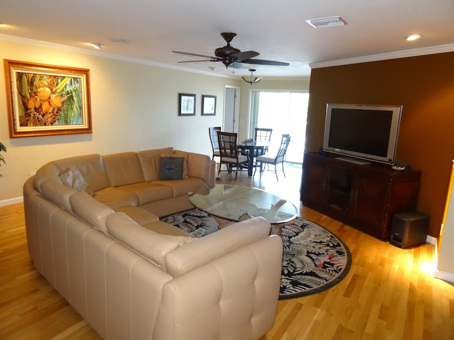 Living room and dining room looking out to pool, canal, and mangroves