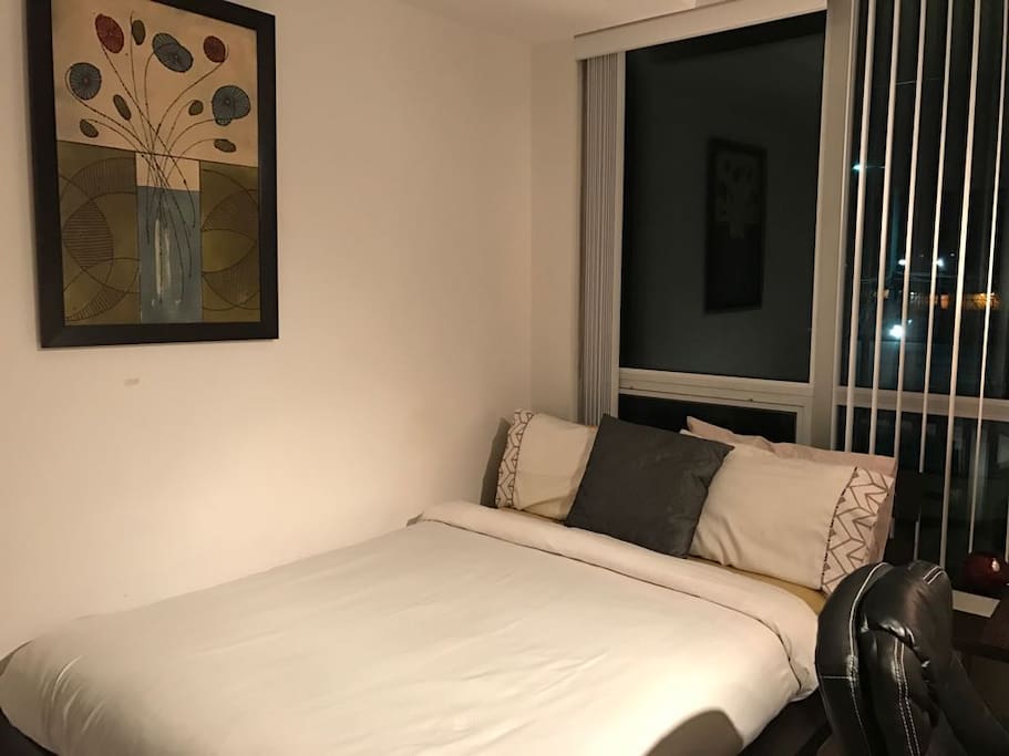 Cosy bedroom with a Queen bed, study table and closet.