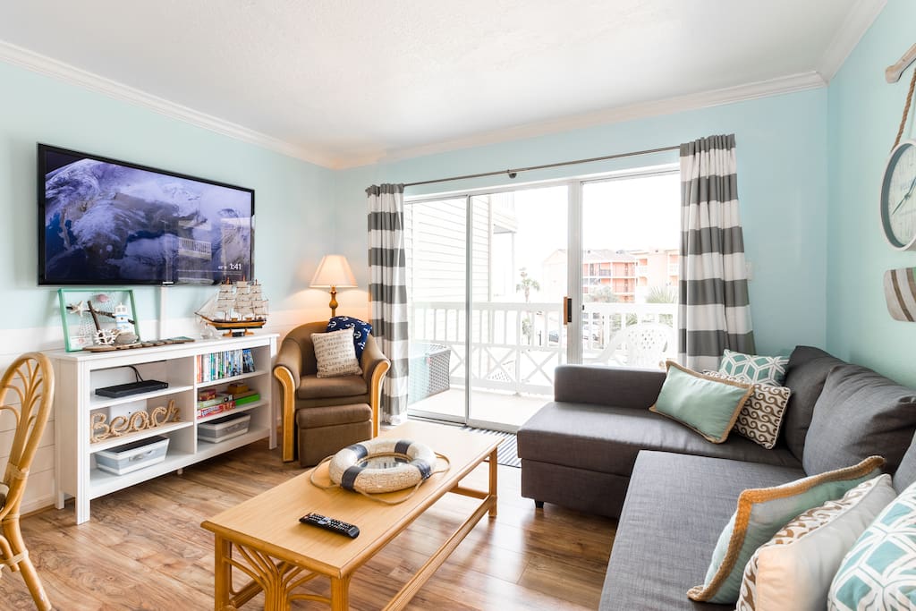 The sliding glass door leading to the balcony from the living room gives you a great view of the pool and beach and tons of sunlight.