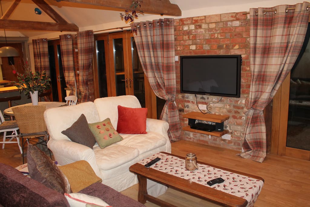 Cosy lounge in the evening with plasma TV and fire