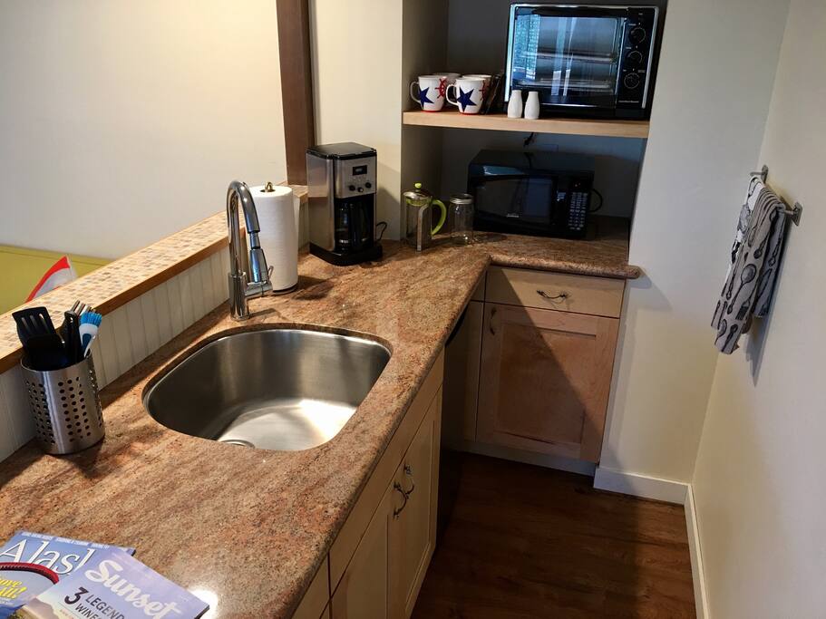 Kitchenette complete with sink, fridge, coffee pot, microwave, and convection oven.