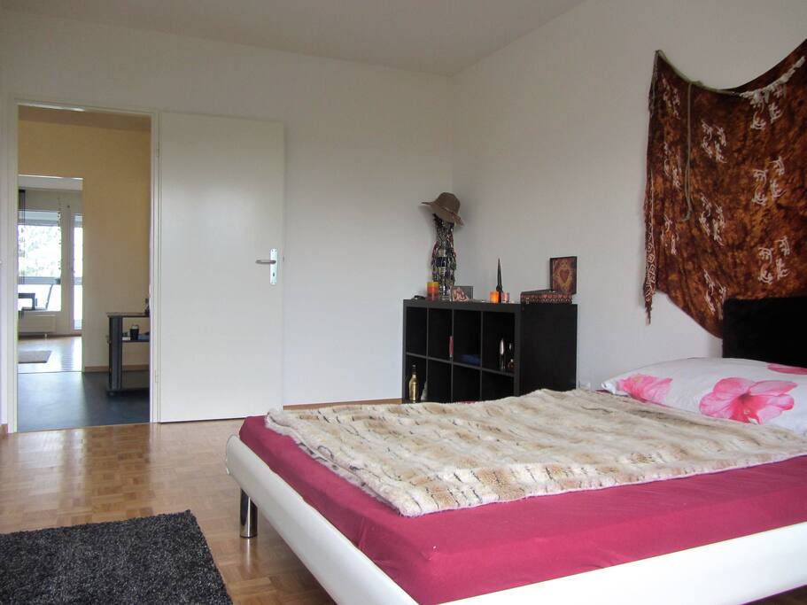 Bedroom with view to the living room and balcony
