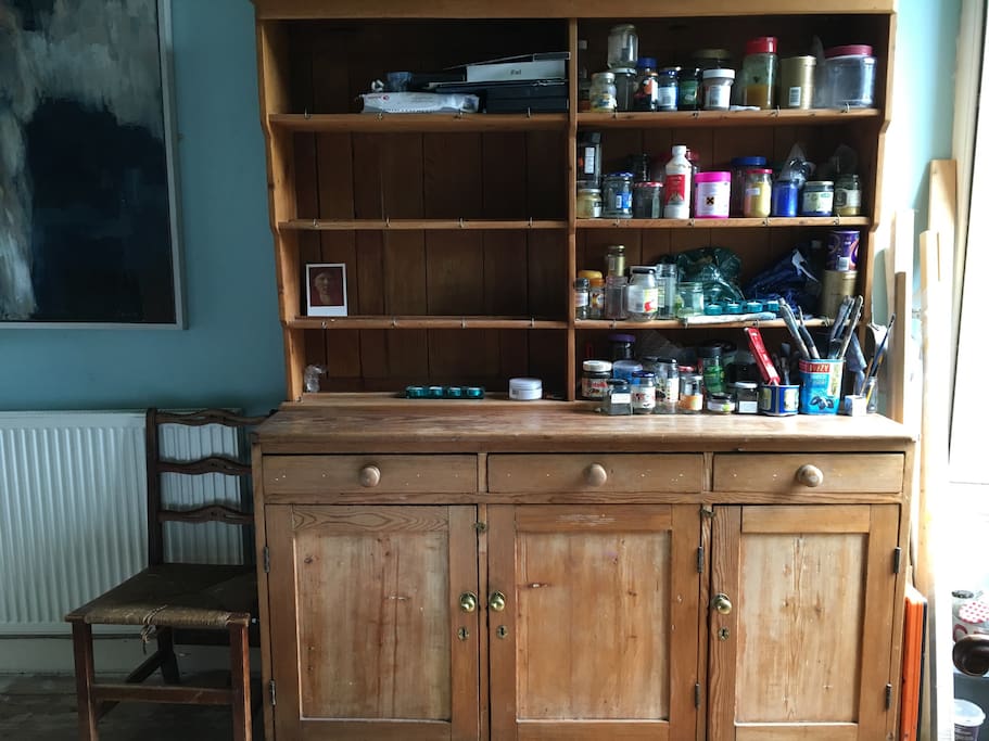 Dresser with pots and paints. Half of the shelves are cleared for your use as well as the middle cupboard.