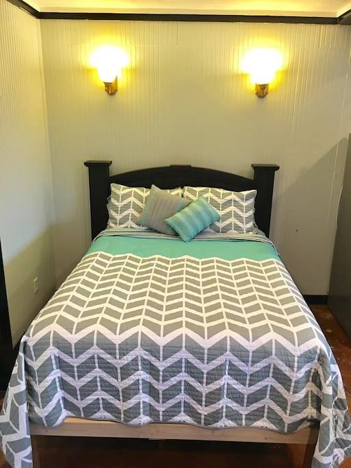 Extra queen size bed located in main room.