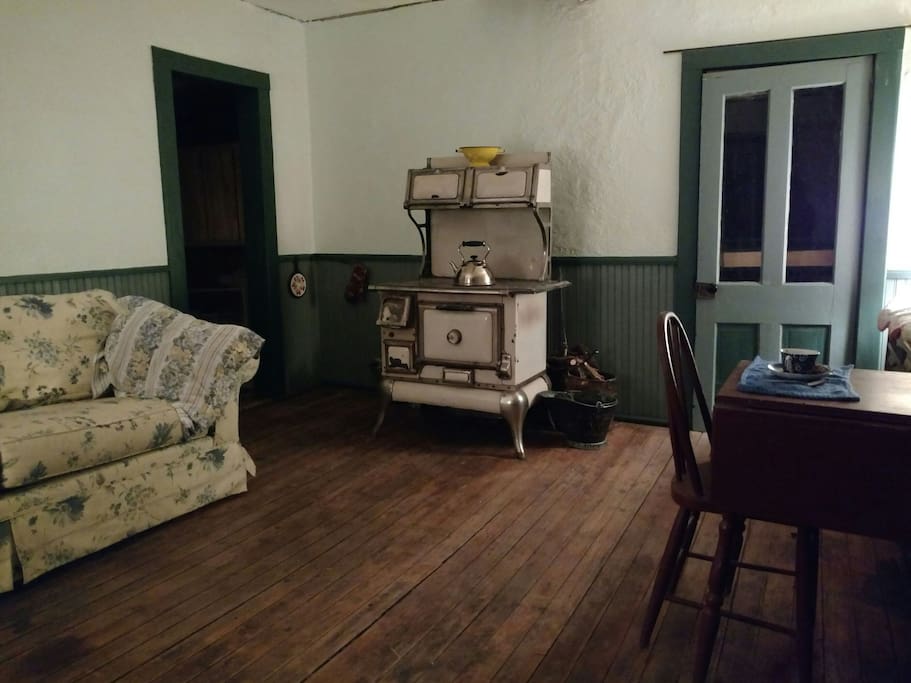A comfortable sofa/couch/double bed has been moved into the cottage as a place to sleep while the loft is being worked on. The loft is available now only to those willing to climb a ladder to the second floor and deal with construction going on around the chimney area.
