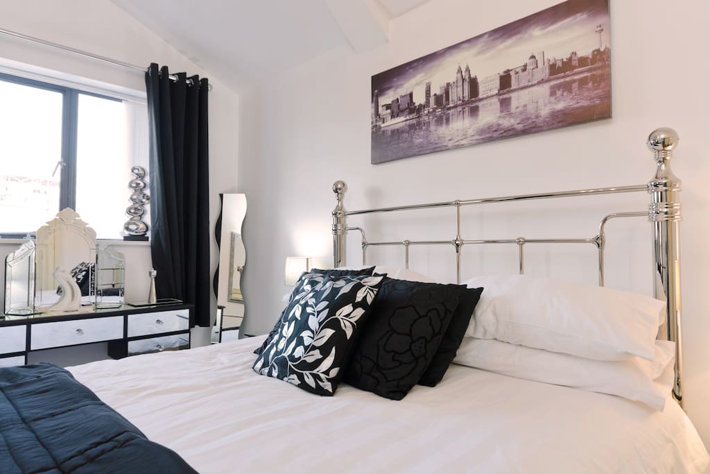 The bedroom with king size iron bedstead and memory foam mattress with glass furniture.