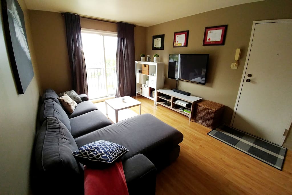 Living room with television and balcony
