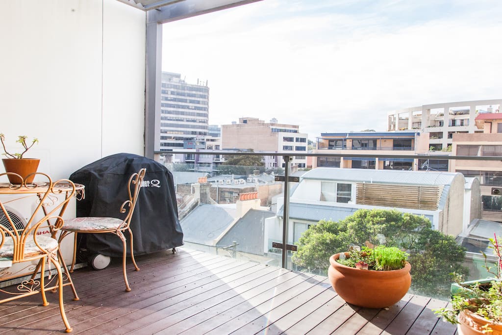 East facing top floor balcony with seating and bbq