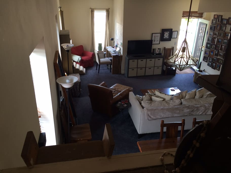 View from loft to living room. Trunks provide a screen for privacy.