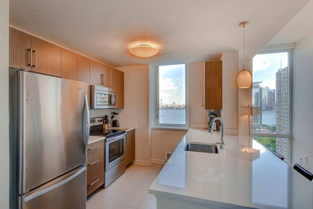 Fully equipped kitchen with full size stainless steel appliances, pots, pans and dishes