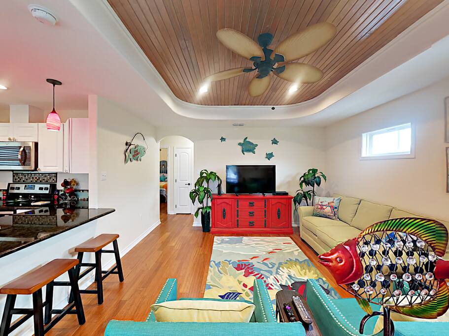 Chic armchairs and a 3-seat sleeper sofa that converts to a queen bed in the living room