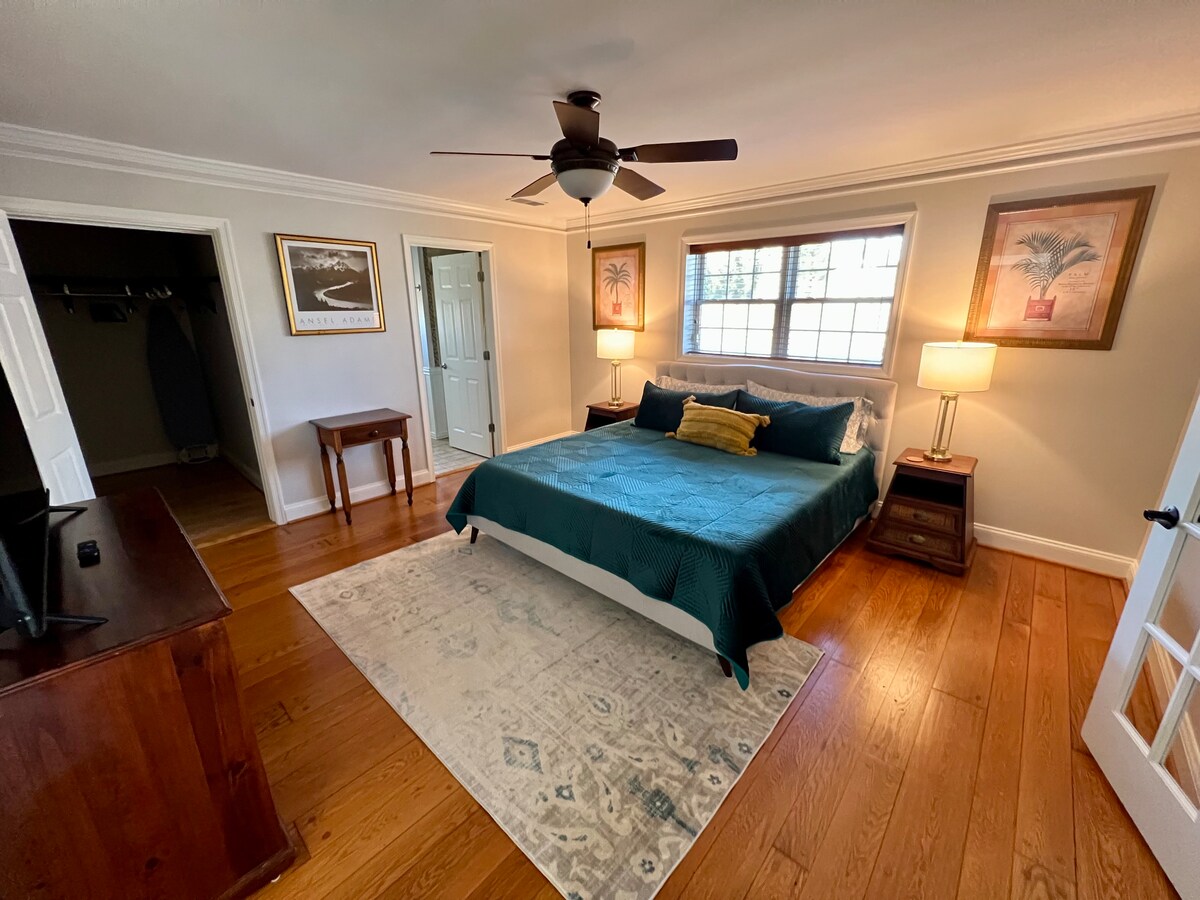 Master Bedroom, equipped with an en suit bath, spacious walk-in closet, 55” Smart TV and private den with sleeper sofa. 