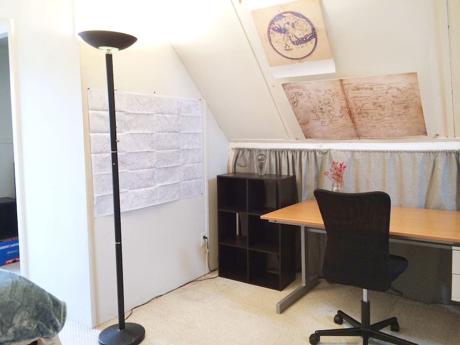 The room has a big sturdy desk and a lot of maps on the walls. We like maps.