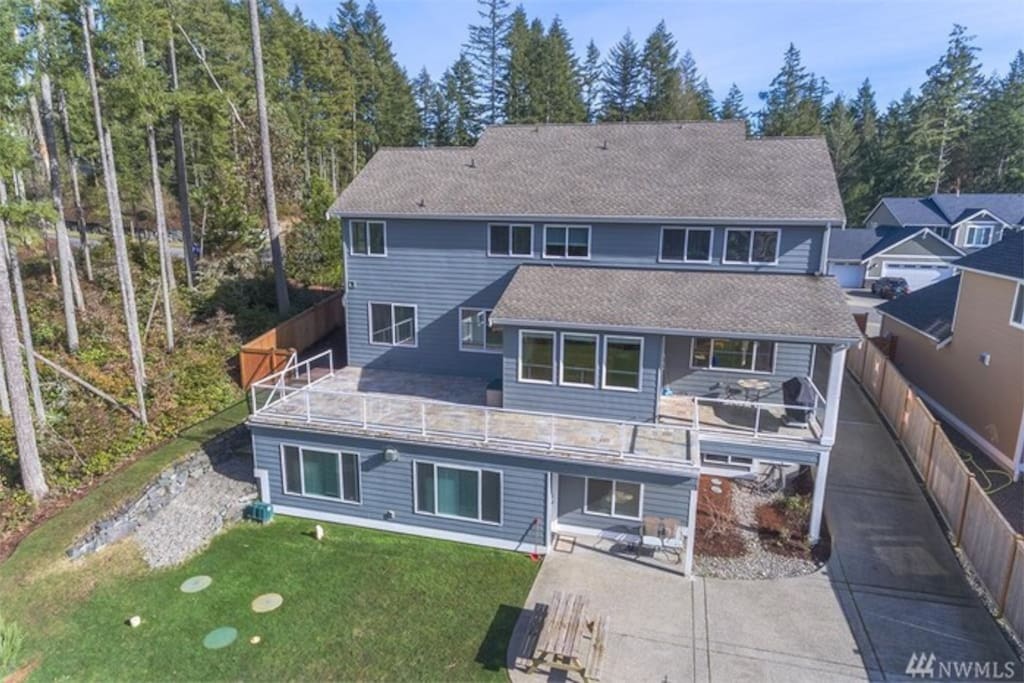 Separate drive and parking and patio with picnic table, outdoor seating and grill.