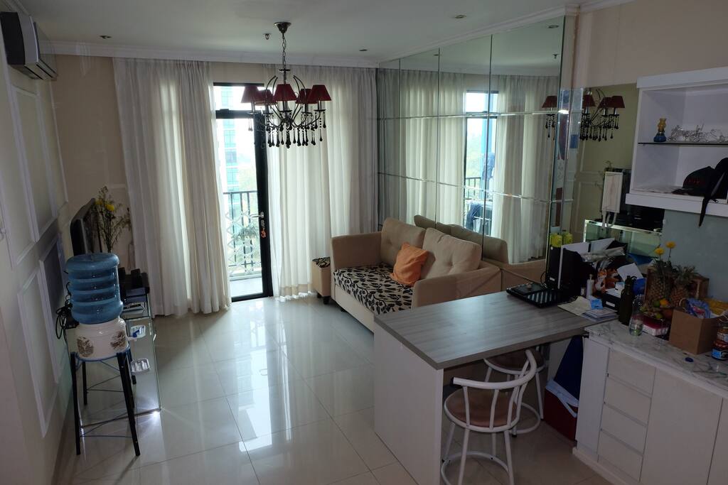 Living Room complete with Tv Cable and High Speed Internet. Patio with Swimming Pool view.