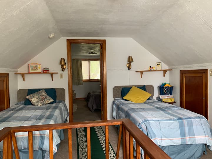 Pair of twin beds in 1st upstairs bedroom. Walk through this bedroom to access the second upstairs bedroom.