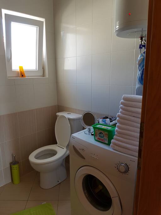 First door to the left is bathroom with washing machine.