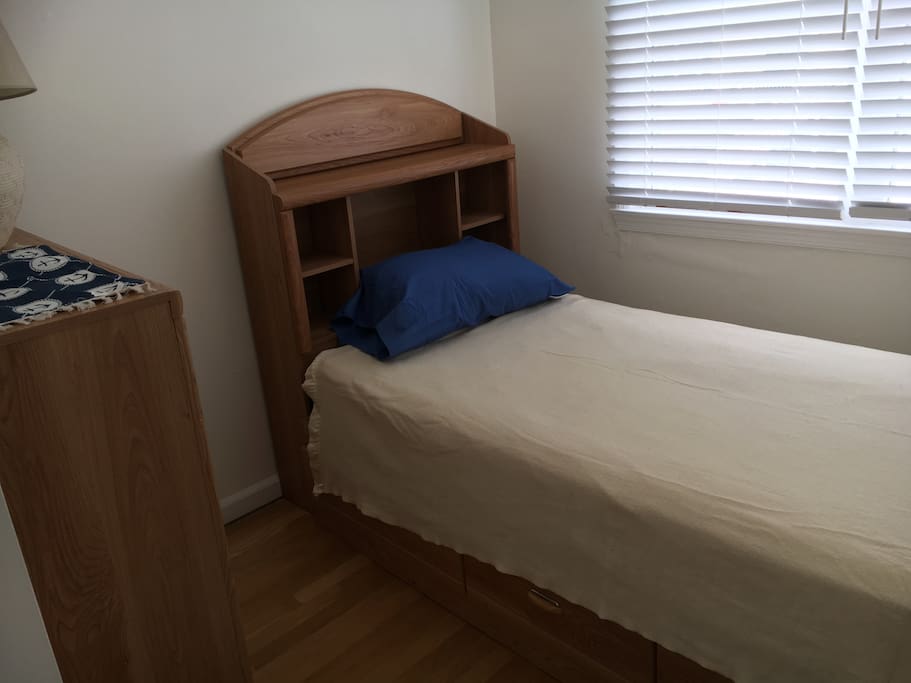 Bedroom 3. Twin bed with dresser and drawers under bed.