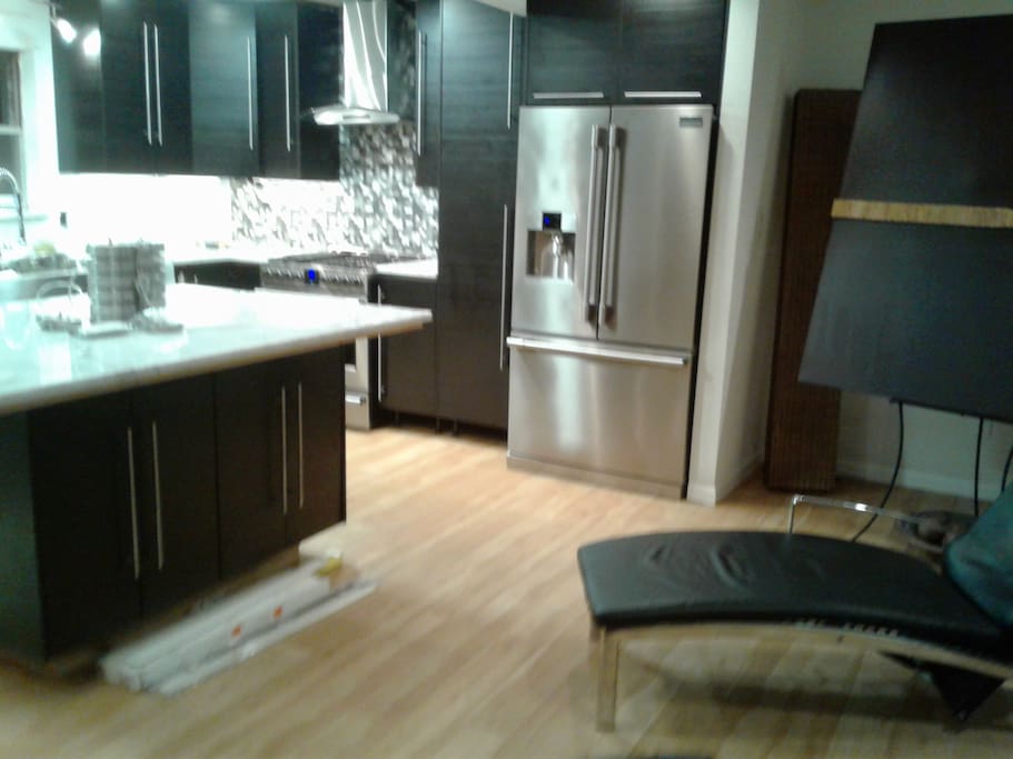 Open Kitchen w/Stainless steel appliances, microwave and dishwasher