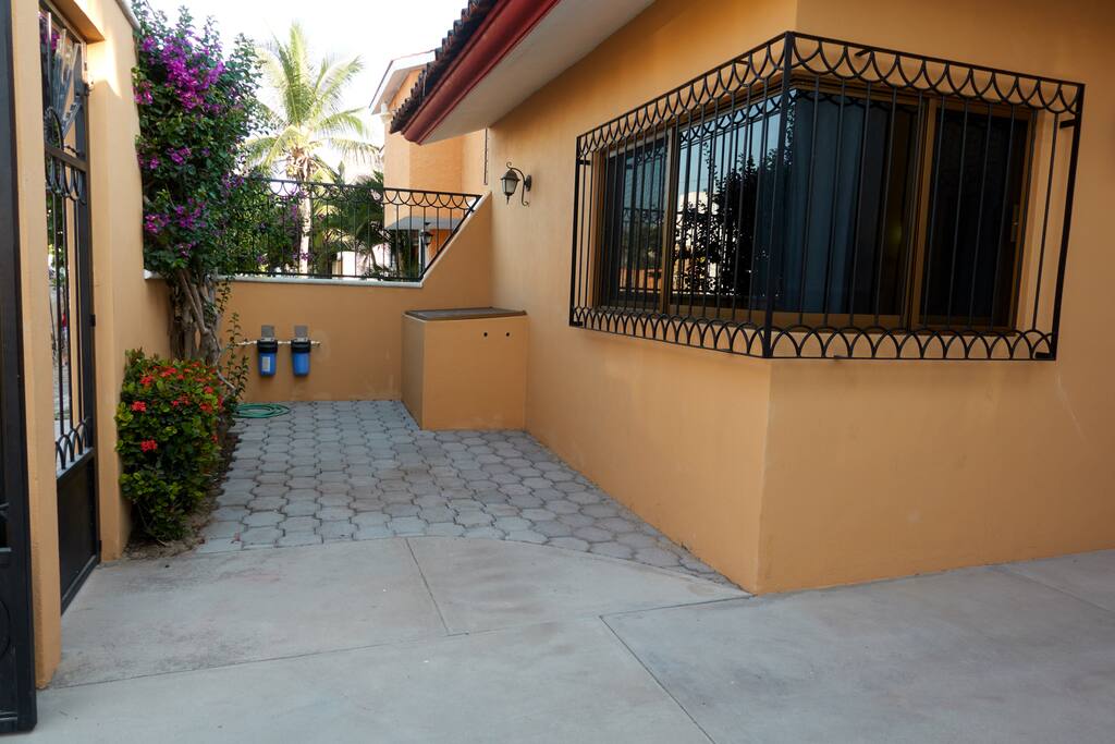 Gated carport entrance. Fits small SUV or van. Room for bicycles or motorcycles too!