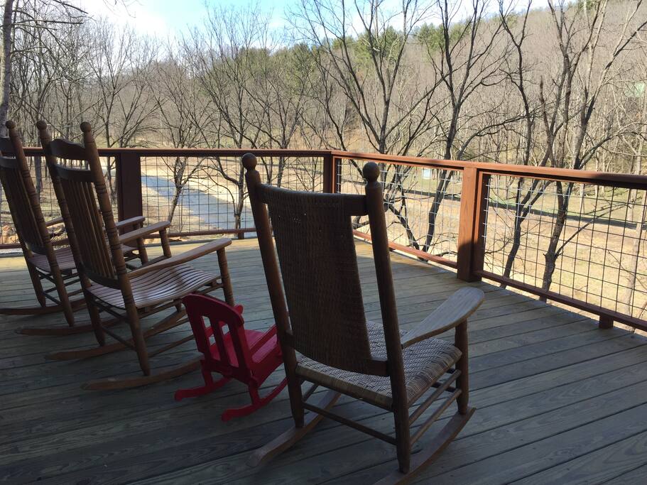 Relax in a rocker on the porch overlooking the river. This is early spring before everything turns green.