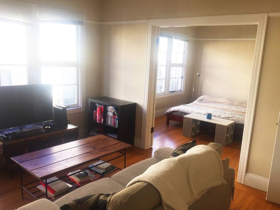 French doors open and close between the living room and bedroom
