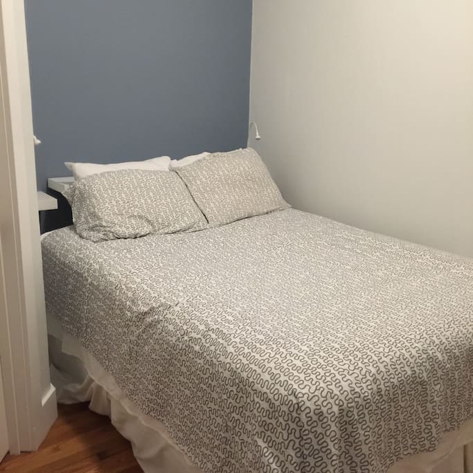 A small bedroom is just big enough to have a queen bed.