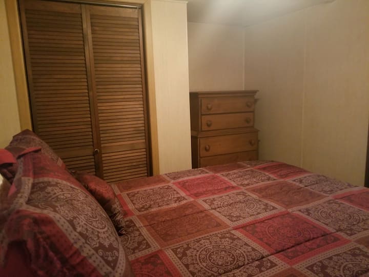 Bedroom with queen-size bed, nightstand, closet and dresser