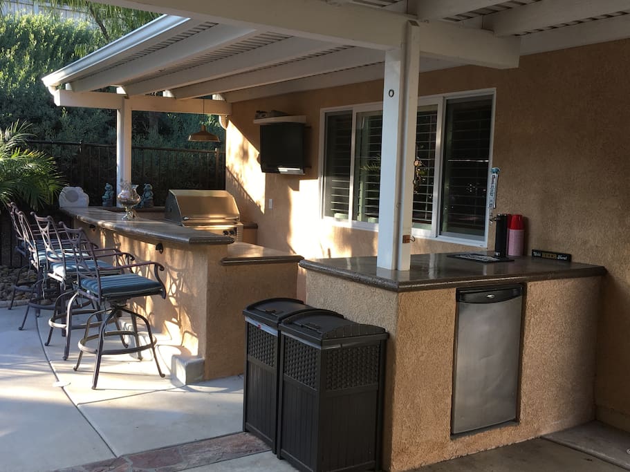 Outdoor cooking and entertainment area; BBQ, TV, Bar and refrigerator.
