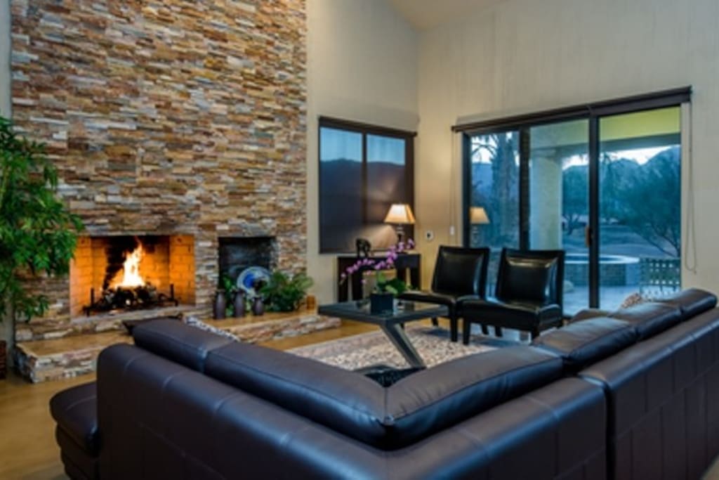 Family room with wood burning fireplace and seating for eight.