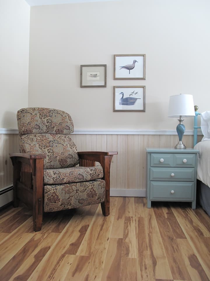 Comfy recliner and nightstand with drawers. 