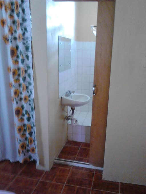 Bathroom with toilet and shower area. Clean towels are also provided.